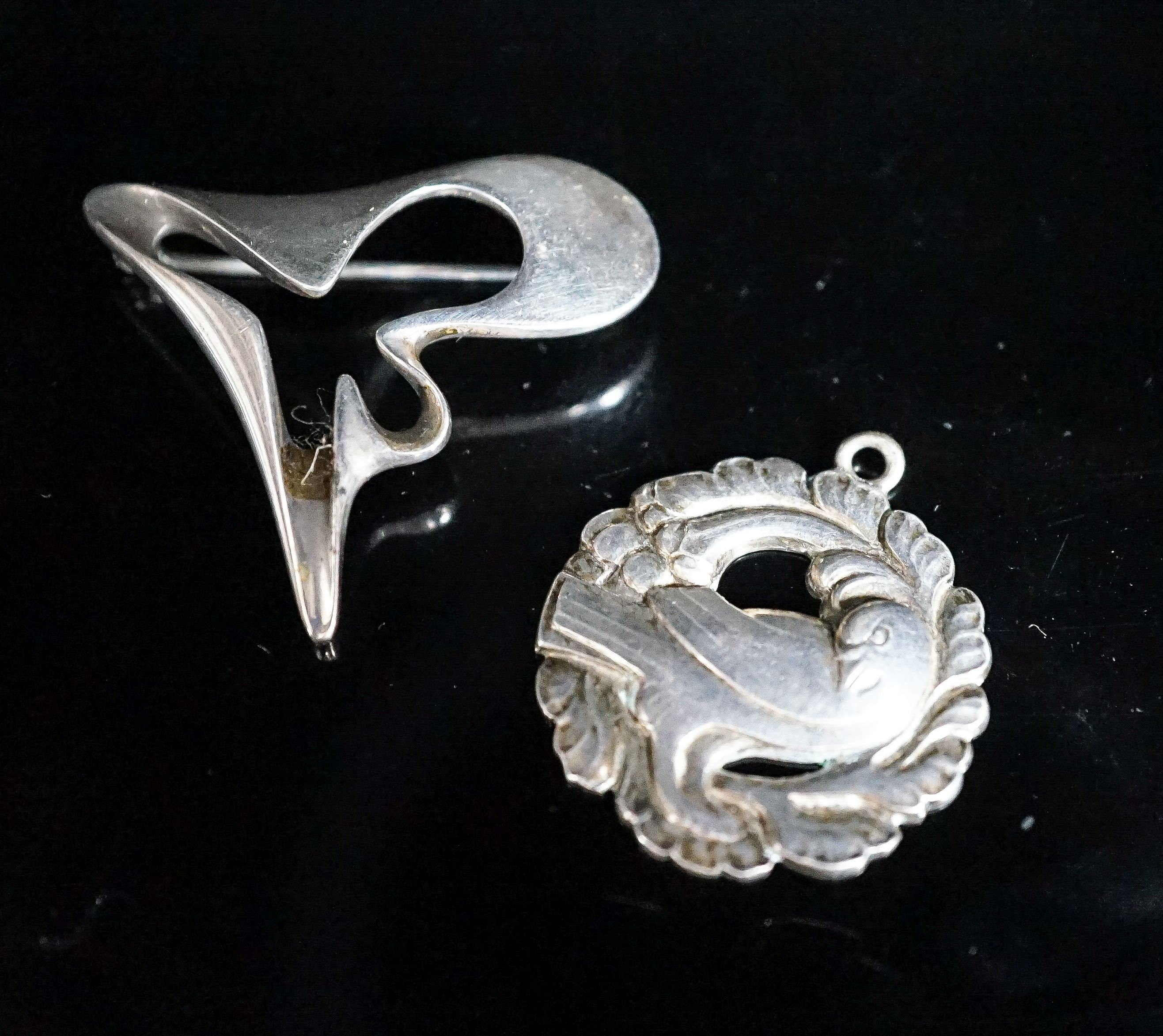 A Georg Jensen sterling abstract brooch, no. 324, 41mm and a Georg Jensen sterling pendant (converted brooch), no. 134.